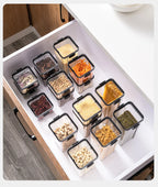 Set of food storage containers with various foods inside, organized in a kitchen drawer.