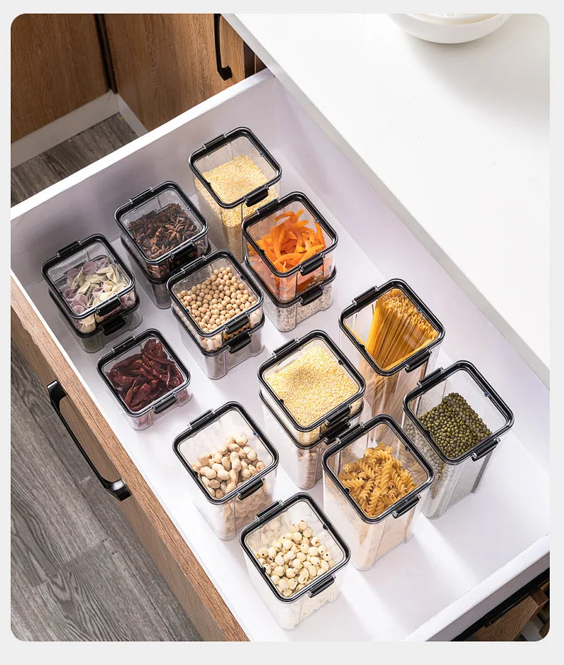 Set of food storage containers with various foods inside, organized in a kitchen drawer.