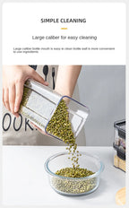 Person pouring green beans from a large caliber bottle into a glass bowl on a white surface.